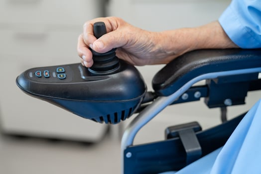 senior woman patient on electric wheelchair with remote control at hospital, healthy strong medical. photo