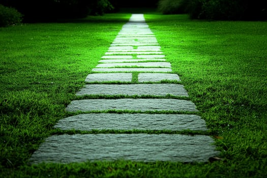 A stone path leads to a green grassy area photo