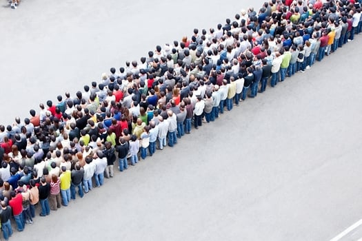 A large crowd of people standing in a line photo