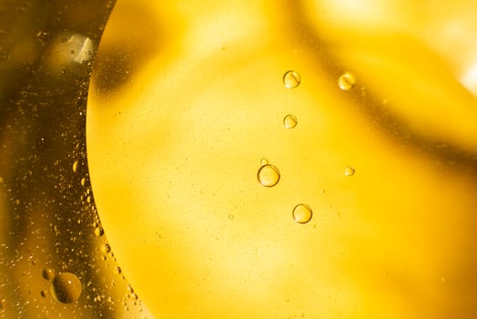 Gold Oil bubbles. circles of orange water macro. yellow background photo