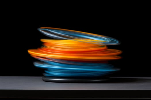 A stack of colorful rings on a black surface photo