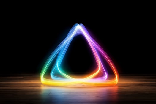 A triangle shaped light is shown in the dark photo