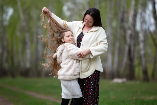Little girl with her mother in the forest photo
