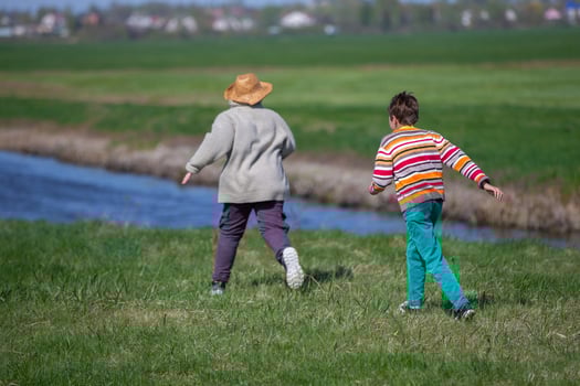 Two boys running after each other in nature Children on summer holidays. photo