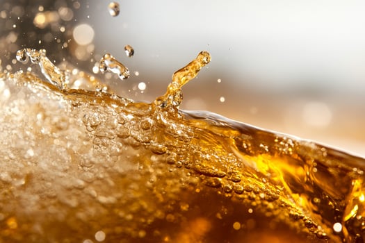 A close up of a soda being poured into a glass photo
