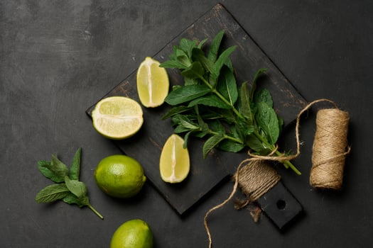 Bunch of fresh green mint and lime wedges on wooden board photo
