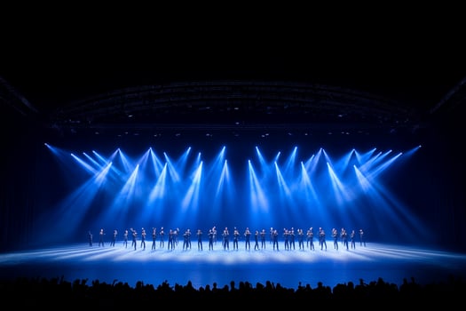 A group of dancers on stage with bright lights photo