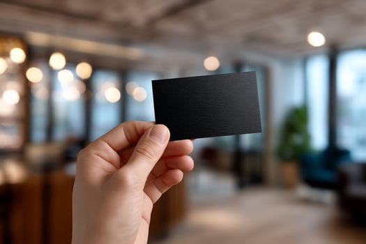Blank black business card held in hand photo