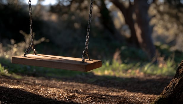 Wooden swing in a sunny, quiet garden photo