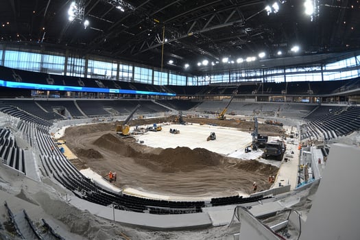 A large arena with dirt and construction equipment photo