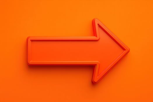 A bold orange arrow is displayed prominently against a matching bright orange background. This eye-catching design directs attention to the right in a visually stimulating way. photo