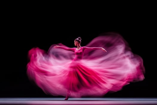 A woman in a pink dress is dancing photo