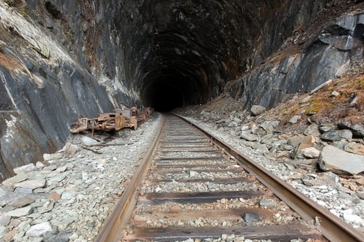 A train track going through a tunnel photo