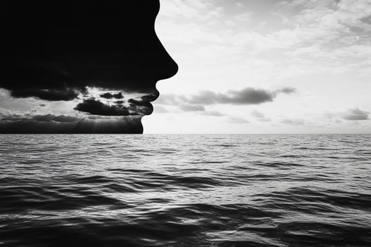A man's face is in the water with clouds in the background photo