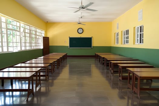 A classroom with desks and a blackboard photo