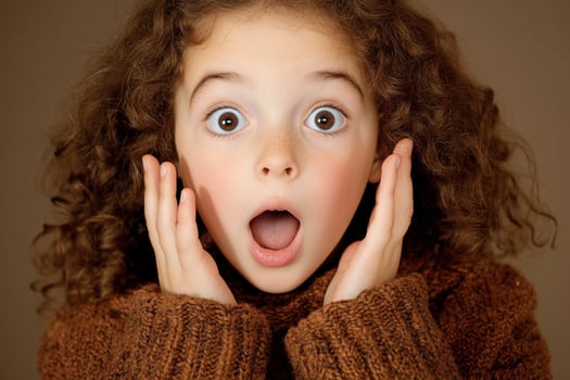 A young girl with a surprised look on her face photo