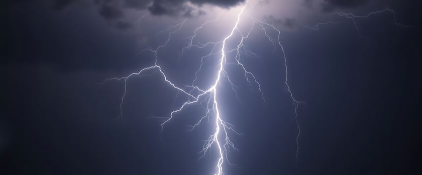 lightning bolt striking through a cloudy sky photo