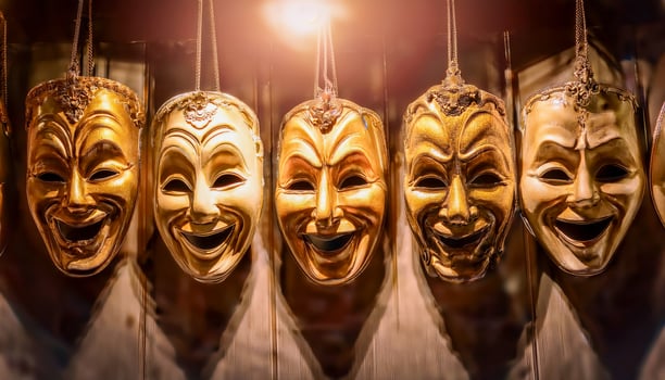 Backstage hangs a row of old theatrical masks, some with wide grins, others downturned in sadness each telling its own silent story in the language of theater photo