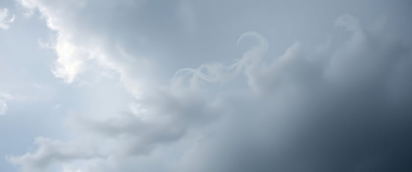 jet flying through a cloudy blue sky photo