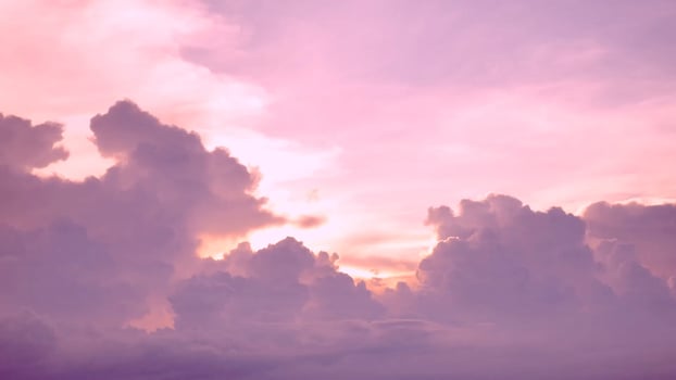 A purple sky with clouds and a pink sunset photo