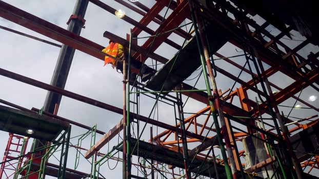 Construction Site with Steel Framework and Scaffolding Under Cloudy Sky, Highlighting Industrial Progress and Urban Development photo