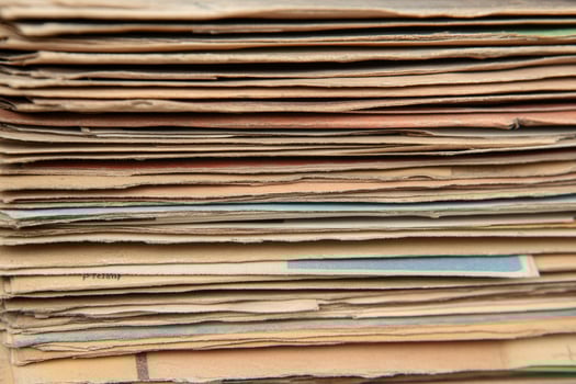 Old newspapers stacked on top of each other photo