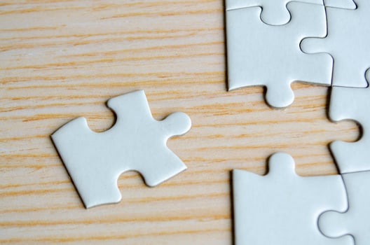 Top view of missing jigsaw puzzle on wooden background photo