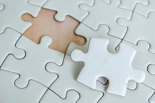 Close up view of interlocking jigsaw puzzle pieces symbolizing problem solving teamwork and collaboration. photo