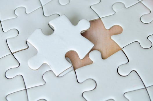 Symbol of partnership and unity shown through connected puzzle pieces photo