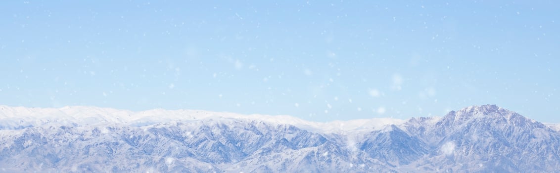 panoramic view of snowy mountains and clouds . photo