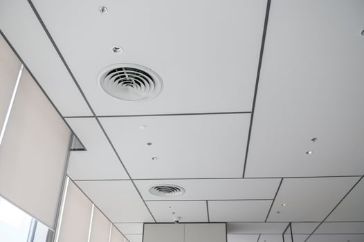 Clean modern office ceiling featuring air vents, recessed lighting, and grid pattern that creates bright and organized atmosphere. design is simple and functional photo