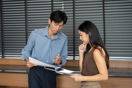 Business Partnership. Professionals collaborating on project details in a contemporary office. photo