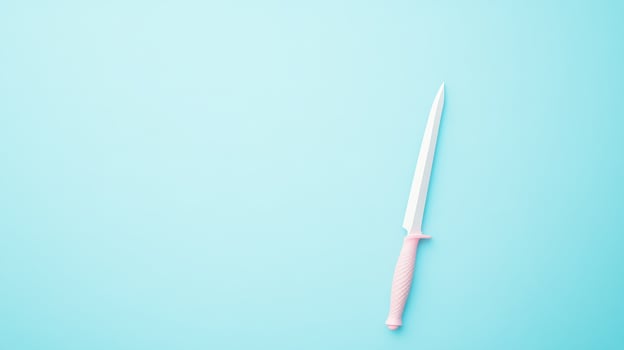 Sharp knife on a pastel blue background photo