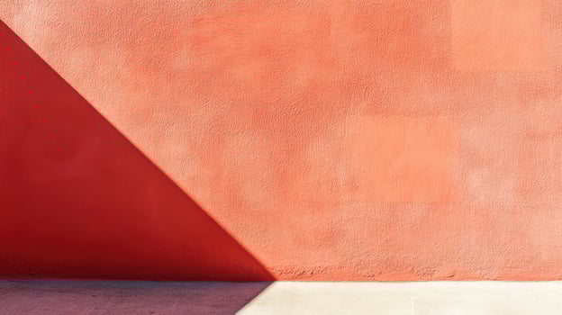 Vibrant orange wall with shadows at midday photo