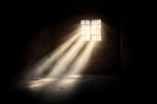 A dark room with sunlight shining through a window photo