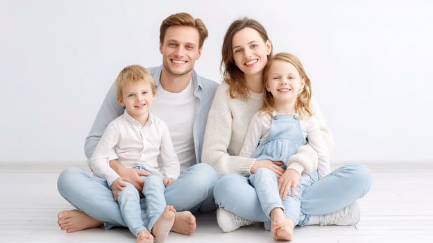 A family sitting on the floor in a white room photo