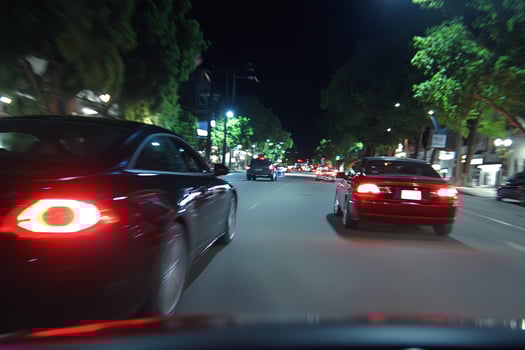 A car driving down the street at night photo