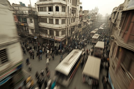 A busy street with lots of people and buses photo