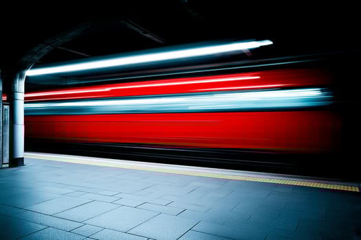 A train is moving through a tunnel at night photo