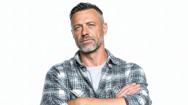 A man with his arms crossed and wearing a plaid shirt photo