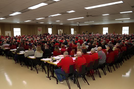 A large room filled with people in red shirts photo