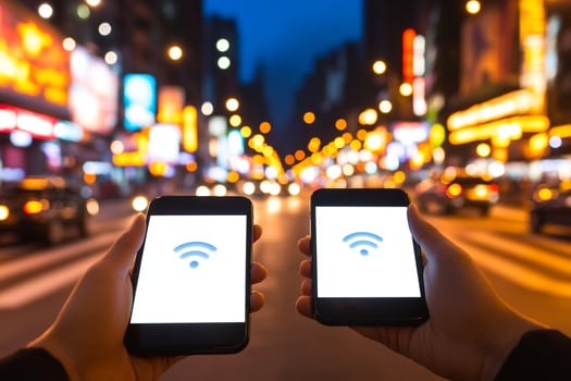 Two hands holding smartphones with wifi icons on them photo