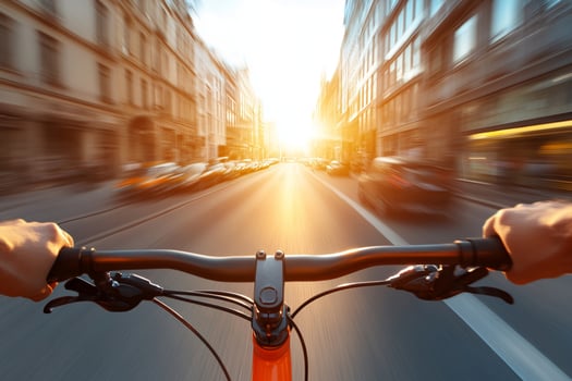 A person riding a bicycle down a city street photo