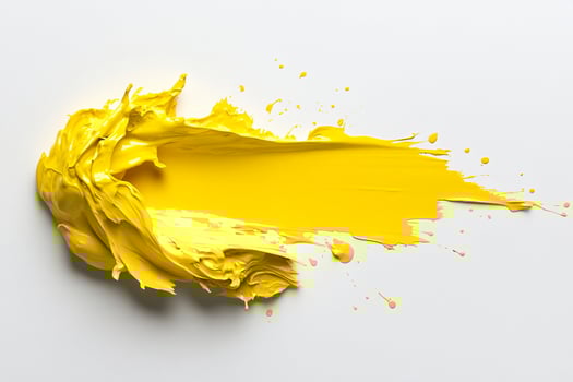 A yellow paint splattered on a white surface photo