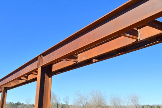 A large steel beam with a blue sky in the background photo