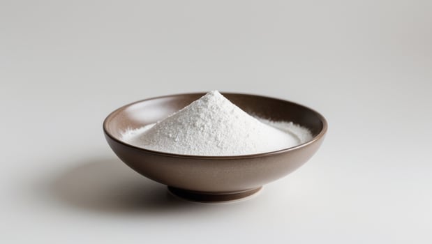 White Powder in a Brown Bowl on a White Background, Minimalist Still Life. photo