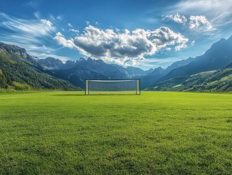 Mountain landscape with soccer goal under blue sky photo