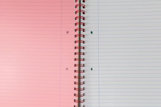 Spiral bound lined notebook with light pink page photo