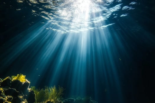 Sunbeams shine through the water in an underwater scene photo