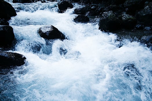 A person on a surf board in a river photo